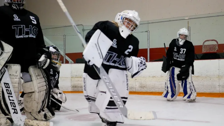 Travis Hoy instructs two young goalies during on-ice training at Travis Hoy Goaltending camp in Vernon, BC