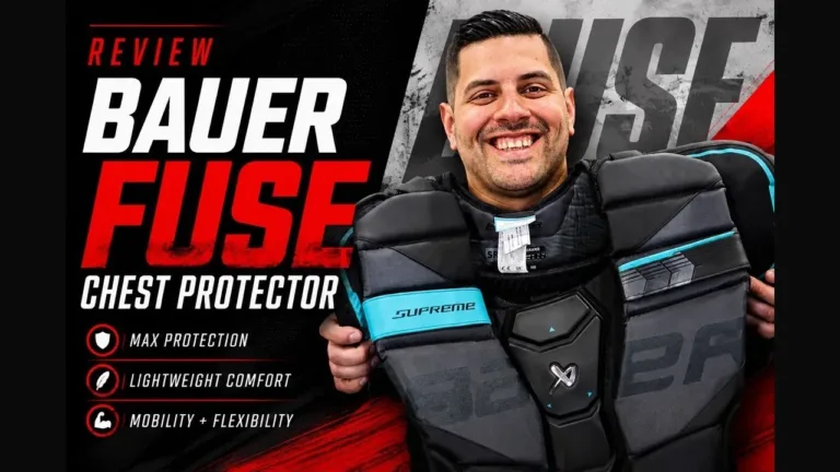 Goalie holding Bauer Fuse chest protector in review image showing front padding, shoulder caps, and teal accents