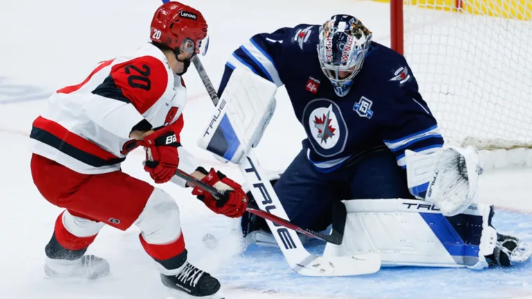 Eric Comrie makes a save for the Winnipeg Jets