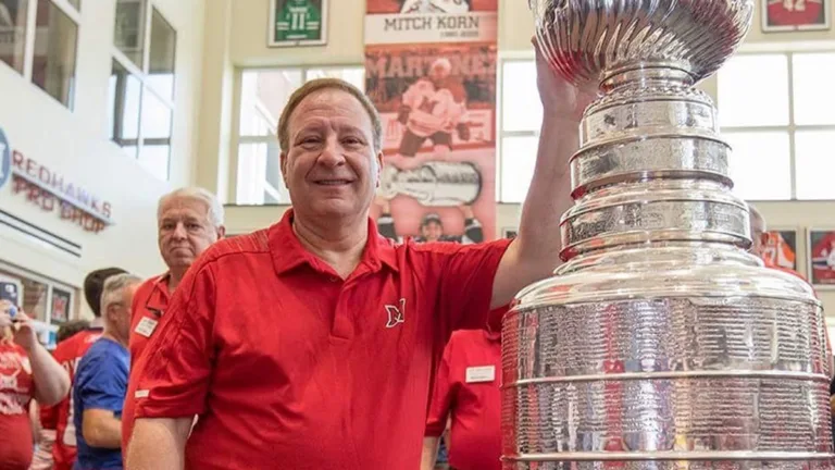 Mitch Korn with the Stanley Cup beneath his Miami RedHawks banner