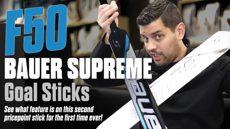 Reviewer holds Bauer Supreme F50 goalie stick, examining the shaft and blade construction during gear review
