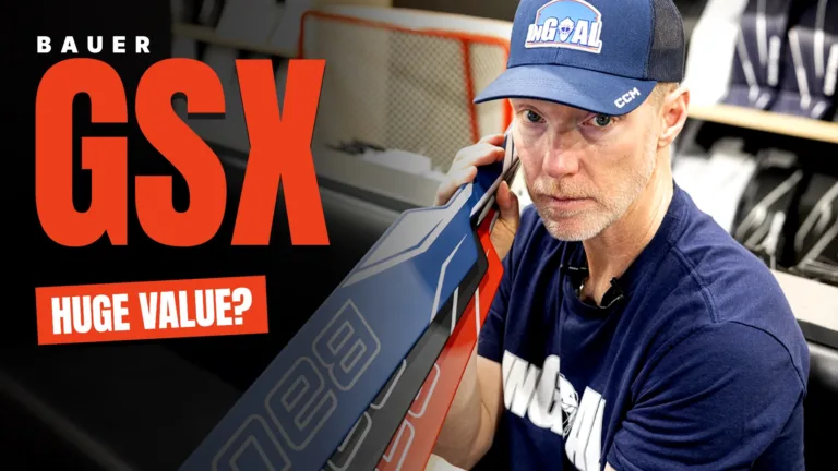 Reviewer examining Bauer GSX goalie stick paddle up close during hands-on gear review