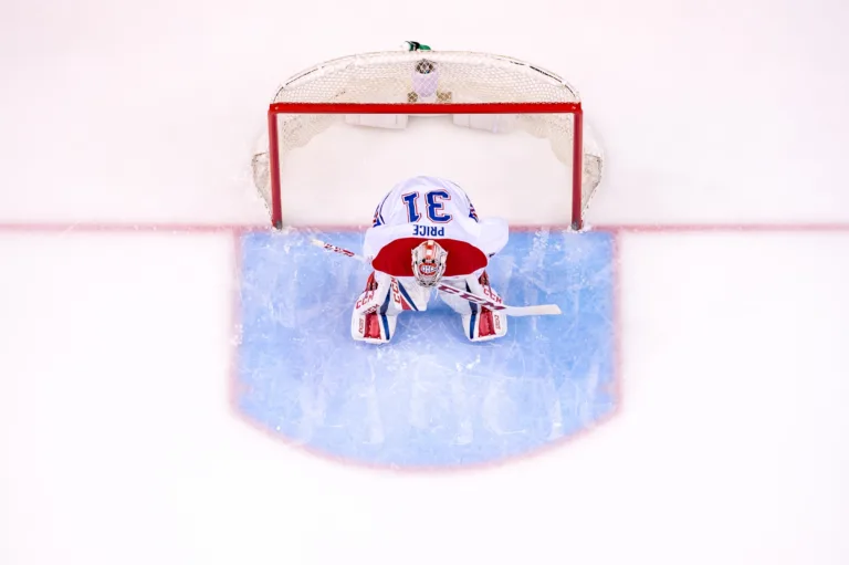 Carey Price of the Montreal Canadiens crouched in his crease, seen from directly above the net