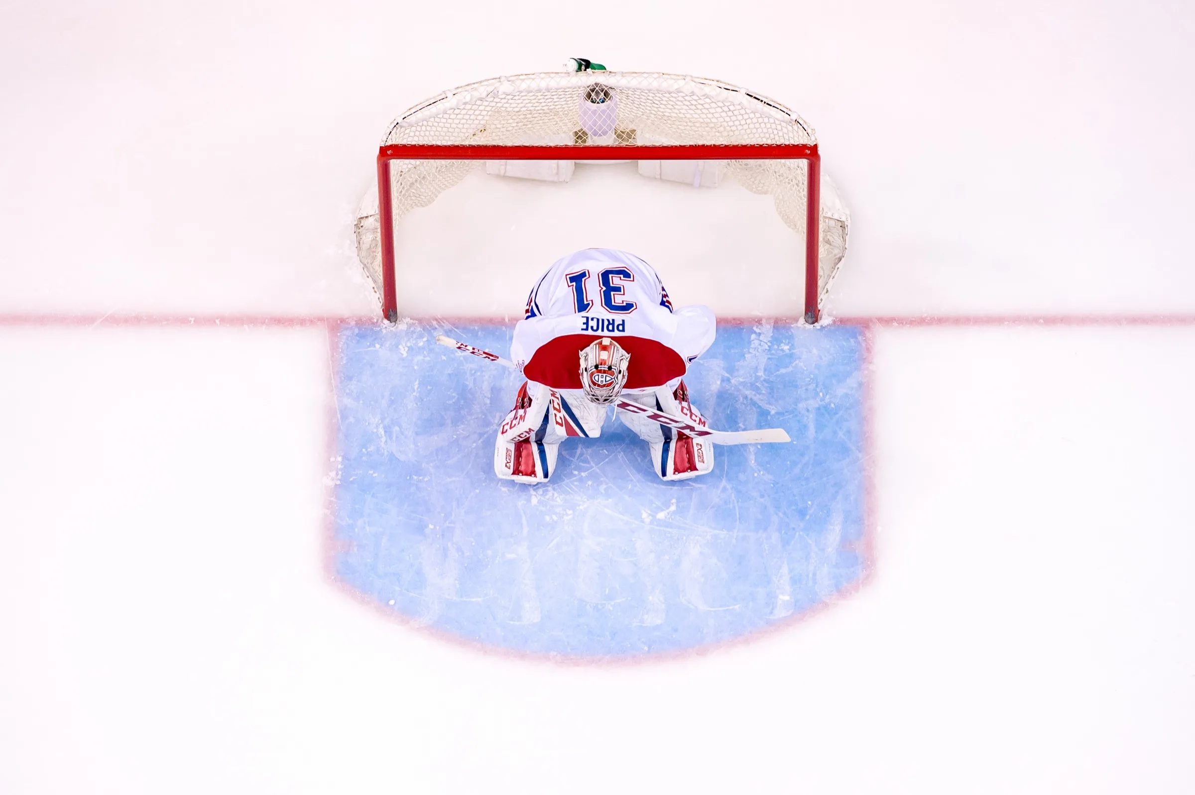 Carey Price of the Montreal Canadiens crouched in his crease, seen from directly above the net