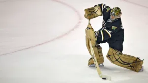 Marty Turco of the Dallas Stars shoots the puck with his glove hand turned over on the stick